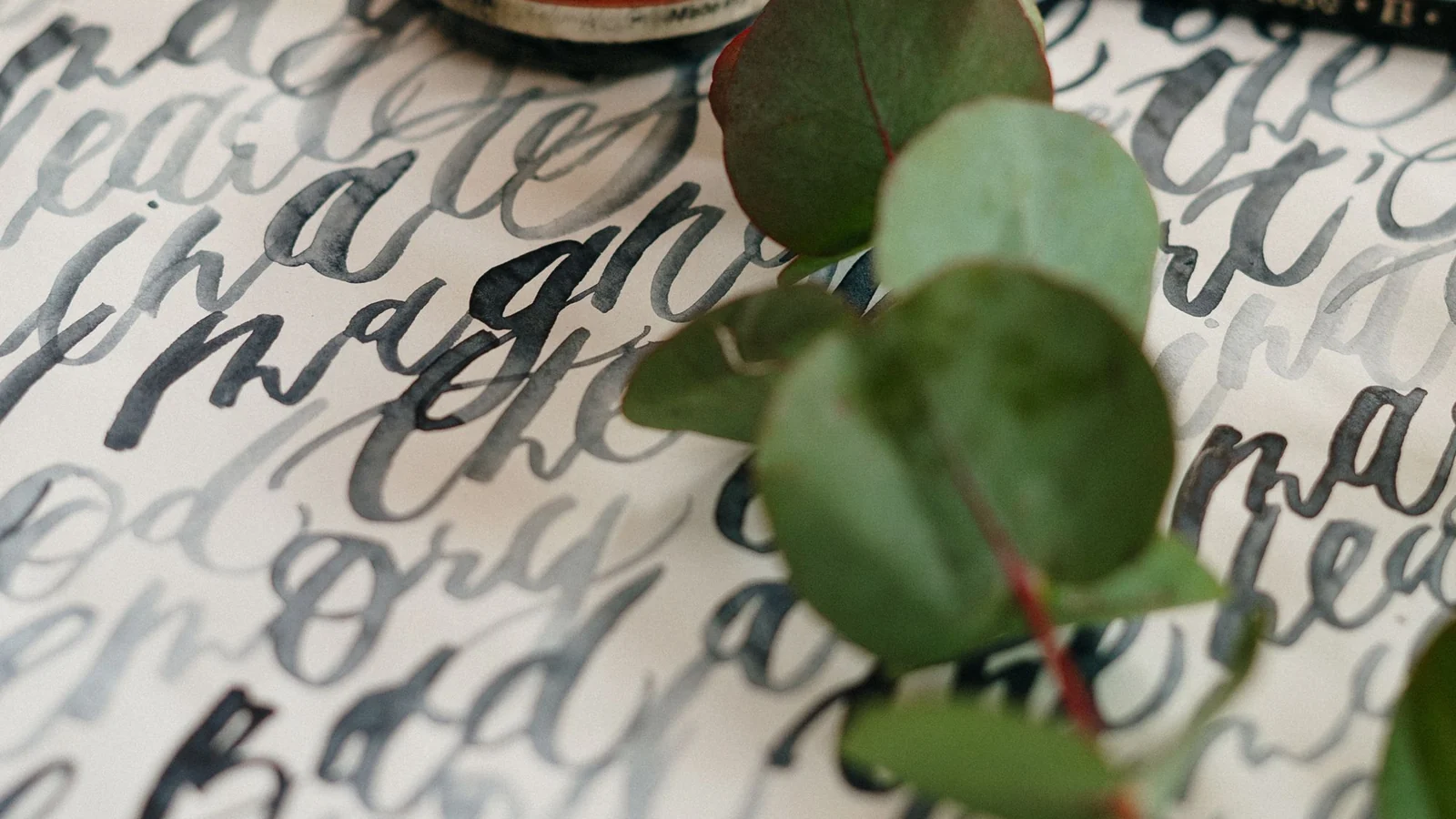 Ink bottle and handwriting in warm light